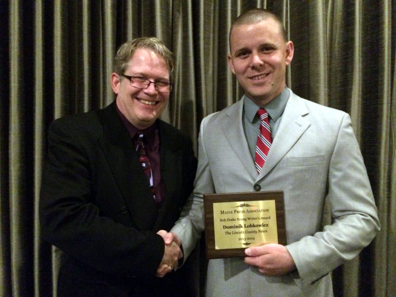 Lincoln County News Editor Sherwood Olin congratulates Dominik Lobkowicz following the presentation of the Bob Drake Young Writer's Award at the Hilton Garden Inn in Auburn Saturday, Oct. 18. (J.W. Oliver photo)