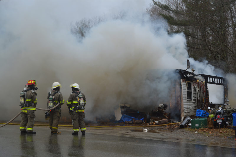 Firefighters work at the scene of a house fire on Lessner Road in Damariscotta on Thursday, April 7. (Maia Zewert photo)