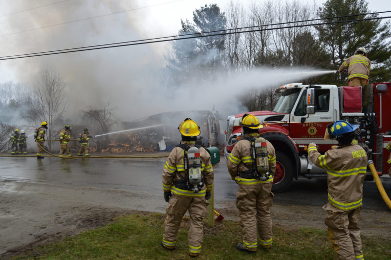 Firefighters from Damariscotta and Bristol work to extinguish a house fire on Lessner Road in Damariscotta on Thursday, April 7. (Maia Zewert photo)