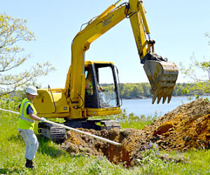 Aaron Martin (left), of Ransom Consulting, and Mike Fournier, of Environmental Projects Inc., dig a test pit on the northern portion of the Mason Station property Thursday, May 26. (Abigail Adams photo)