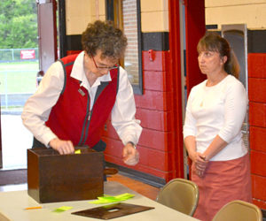 Election Clerk Joan Barnes (left) tallies results of the secret ballot vote at the Wiscasset School Department budget meeting May 25. Town Clerk Linda Perry looks on. (Abigail Adams photo)