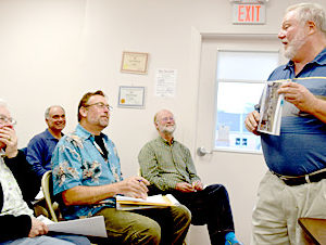Arlene Cole reacts as Newcastle Selectman Brian Foote (right) announces the dedication of the annual town report to the 50-year ballot clerk and volunteer. (J.W. Oliver photo)