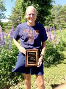 Dr. Stephen Reed, of Wiscasset, holds his 2016 United States Running Streak Association Runner of the Week plaque. On Thursday, June 16, Reed's streak of running 3 miles a day, every day, hit 40 years. (Photo courtesy Ann Hinck)