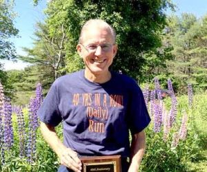 Dr. Stephen Reed, of Wiscasset, holds his 2016 United States Running Streak Association Runner of the Week plaque. On Thursday, June 16, Reed's streak of running 3 miles a day, every day, hit 40 years. (Photo courtesy Ann Hinck)