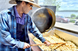 Wade Cameron Ingham makes the all-natural popcorn on the front patio, where customers can watch and test new flavors. (Haley Bascom photo)