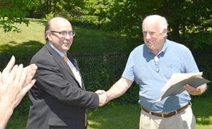 Maine Secretary of State Matthew Dunlap (left) shakes hands with Bristol Village Improvement Society President Don Means on June 22. Dunlap recognized the society for 100 years of incorporation. (Haley Bascom photo)