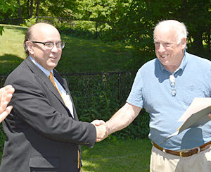 Maine Secretary of State Matthew Dunlap (left) shakes hands with Bristol Village Improvement Society President Don Means on June 22. Dunlap recognized the society for 100 years of incorporation. (Haley Bascom photo)