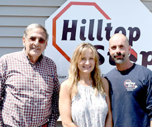 From left: Dan Goldenson, Jane Gravel, and Gary Gravel stand outside Hilltop Stop in Damariscotta on Friday, June 24. Goldenson is buying the property from the Gravels, but Gary Gravel will continue to run the business. (J.W. Oliver photo)