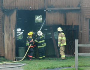 Local firefighters work at the scene of a boathouse fire on Friendship Road in Waldoboro. (Alexander Violo photo)