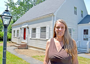 Pemaquid Watershed Association Executive Director Jennifer Hicks stands in front of the organization’s headquarters in Damariscotta. (Maia Zewert photo)