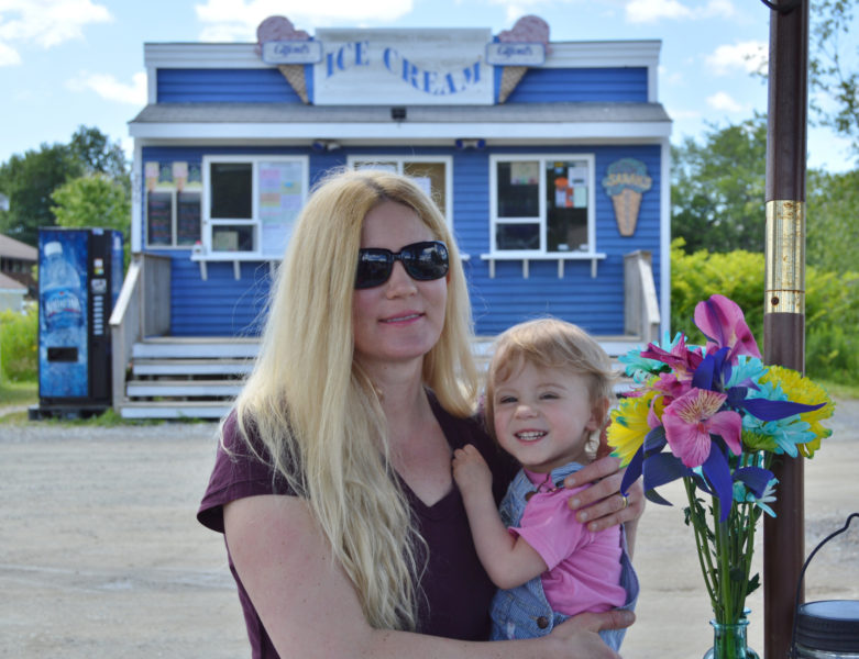 Wild Island Ice Cream co-owner and creator Summer Galvis and her daughter, Emmy, stand in front of Sarah's Scoops in Boothbay Harbor, which sells her ice cream, July 11. (Haley Bascom photo)