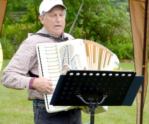 Peter Walsh plays "Red River Valley" on accordion while attendees sing along. (Haley Bascom photo)