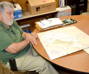 Dr. Jack Sarmanian, of Edgecomb, a Red Cross disaster mental health worker, looks over a map of West Virginia on Tuesday, July 12, following his return from a deployment to assist flood victims. (Abigail Adams photo)