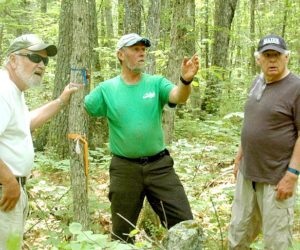 From left: Alna First Selectman David Abbott, Gary Hayward, and Alna Third Selectman Doug Baston look for a marker on the Alna-Jefferson town line. (Alexander Violo photo)