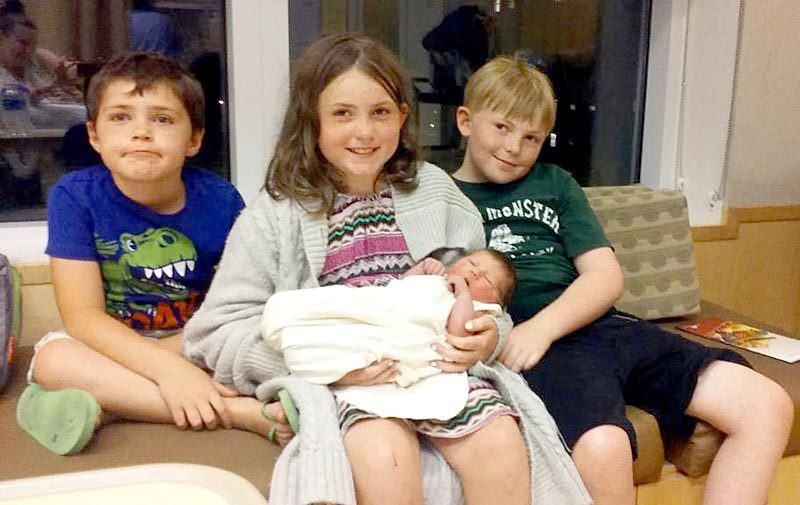 From left: siblings Joseph, Emily, and Gary James Tibbetts sit with their new sister, Madeline Peaslee. The children's mother, Andrea Tibbetts, gave birth to Madeline hours after she was in a car accident on Route 1 in Newcastle the afternoon of Tuesday, July 5. (Photo courtesy Andrea Tibbetts)