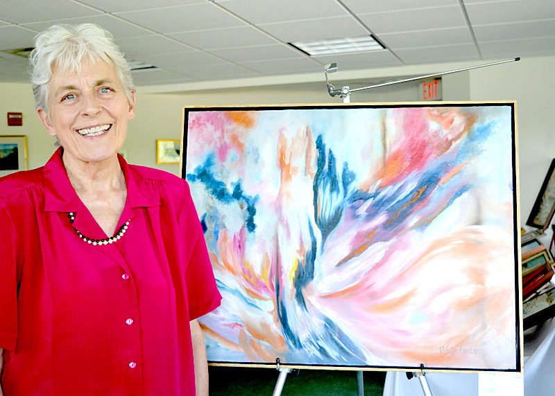Damariscotta artist Polly Steadman stands beside her "wet-on-wet" oil painting "Phoenix" at her recent retrospective show at The Lincoln Home in Newcastle during the Twin Villages ArtWalk. (Christine LaPado-Breglia photo)