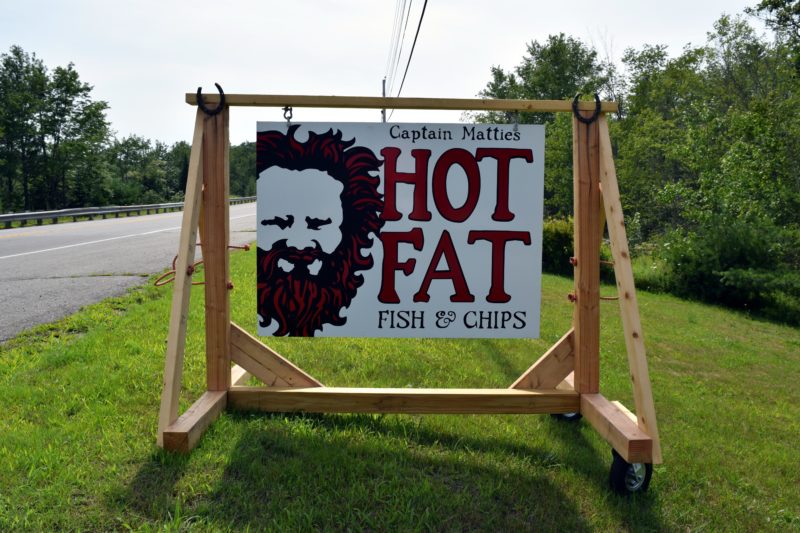 A sign alongside Route 1 in Waldoboro beckons travelers to Captain Mattie's Hot Fat Fish & Chips. (J.W. Oliver photo)