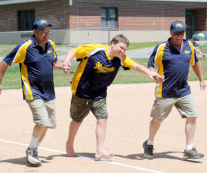 Medomak Valley Challenger Division player Austin Richardson is accompanied by buddies Mark Vannah and Marty Benner. (Paula Roberts photo)