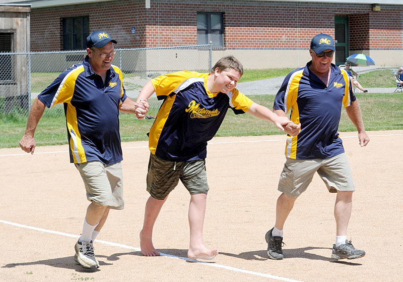 Medomak Valley Challenger Division player Austin Richardson is accompanied by buddies Mark Vannah and Marty Benner. (Paula Roberts photo)