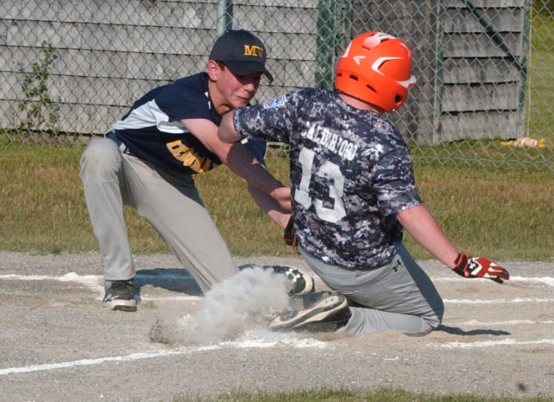 Connor Calderwood scores on a passed ball for Oceanside, as Medomak pithcer Ethan Reed applies the tag. (Carrie Reynolds photo)