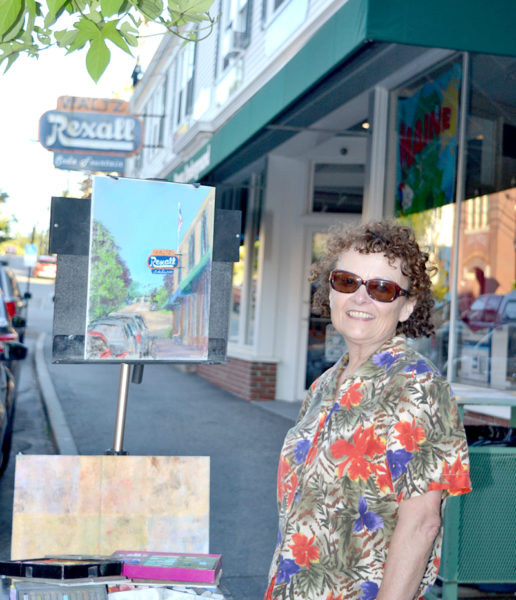 Waldoboro artist Anne Heywood soaked up the ArtWalk atmosphere on Aug. 19 as she painted on Damariscotta's Main Street. (Christine LaPado-Breglia photo)