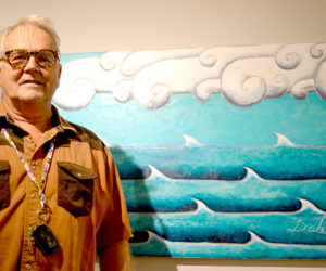 Dale Dapkins stands before his whimsical acrylic painting "Doric Clouds" at the recent opening reception for the "Rock 'n' Wave" art show at the Kefauver Studio & Gallery in Damariscotta. (Christine LaPado-Breglia photo)