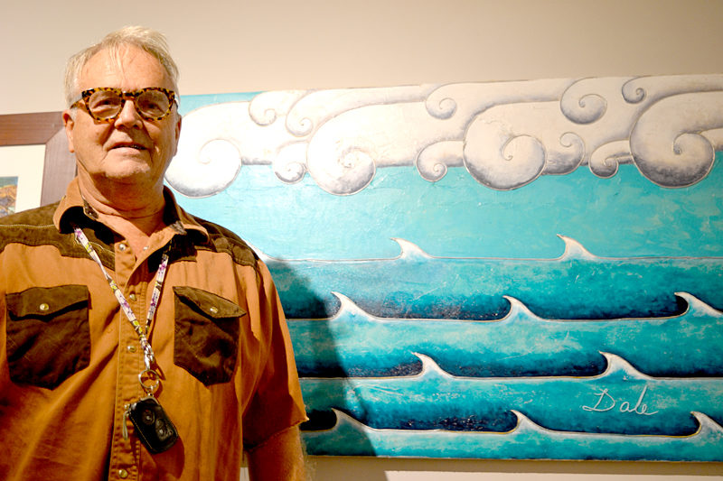 Dale Dapkins stands before his whimsical acrylic painting "Doric Clouds" at the recent opening reception for the "Rock 'n' Wave" art show at the Kefauver Studio & Gallery in Damariscotta. (Christine LaPado-Breglia photo)