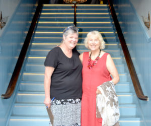 Lincoln Theater Board of Directors member Pam Gormley (left) greets Lincoln Theater member Betsy Heminway at the base of the newly renovated and reopened staircase at the venue's Theater Street entrance on the evening of Thursday, Aug. 11. (Christine LaPado-Breglia photo)