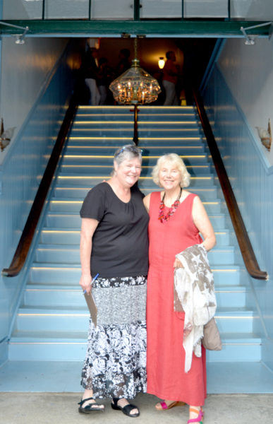 Lincoln Theater Board of Directors member Pam Gormley (left) greets Lincoln Theater member Betsy Heminway at the base of the newly renovated and reopened staircase at the venue's Theater Street entrance on the evening of Thursday, Aug. 11. (Christine LaPado-Breglia photo)