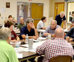 Representatives of the towns of Bremen, Bristol, Damariscotta, Newcastle, Nobleboro, and South Bristol, and of the Central Lincoln County Ambulance Service, Great Salt Bay Sanitary District, Lincoln County Emergency Management Agency, and LincolnHealth, participate in a tabletop exercise at the Damariscotta Fire Department on Thursday, Aug. 18. (Maia Zewert photo)