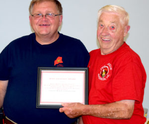 Jefferson Fire Chief and Lincoln County Fire Chiefs Association Vice President Walter Morris (left) presents a Unit Citation Award to Don Hastings, accepting on behalf of the founding members of The Jefferson Volunteer Fire Department. (J.W. Oliver photo)