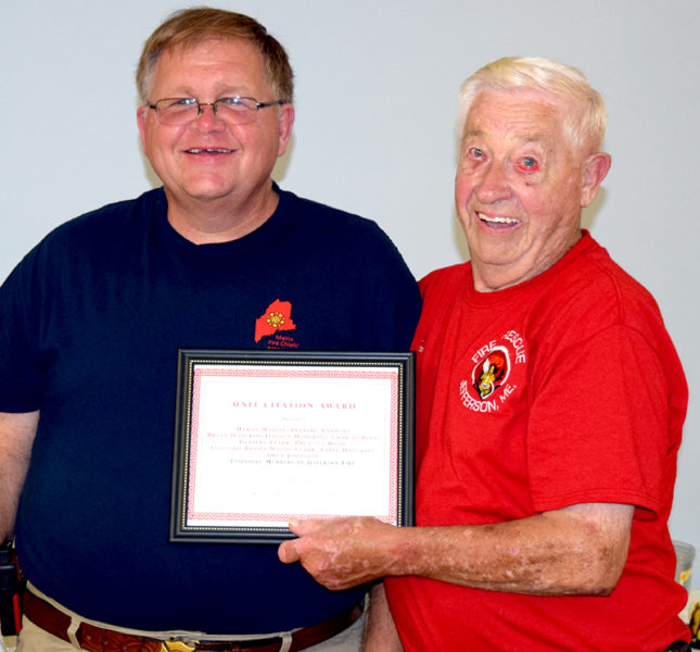 Jefferson Fire Chief and Lincoln County Fire Chiefs Association Vice President Walter Morris (left) presents a Unit Citation Award to Don Hastings, accepting on behalf of the founding members of The Jefferson Volunteer Fire Department. (J.W. Oliver photo)