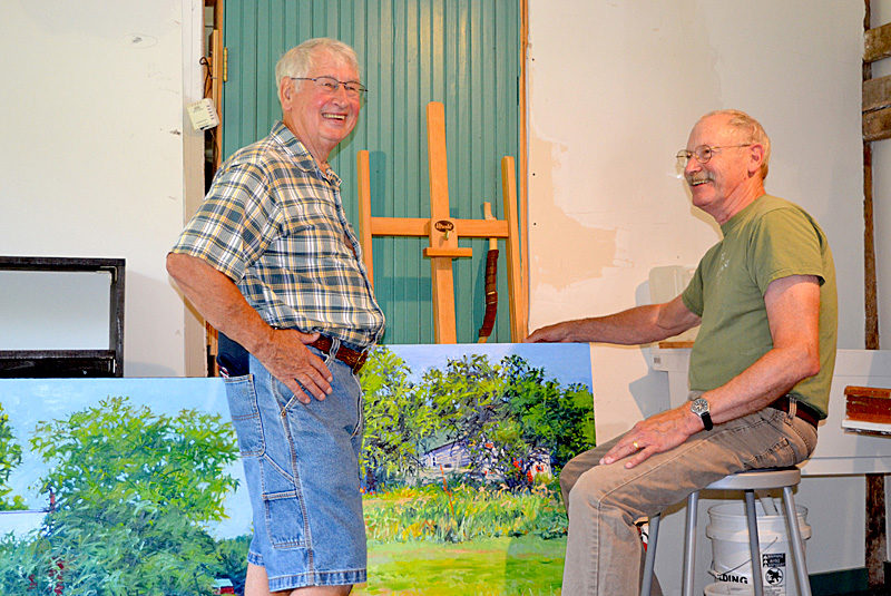 Jefferson artist John Kierstead (left) chats with Readfield artist J. Thomas R. Higgins in the barn studio Higgins occupied for the month of July as an artist-in-residence at the Joseph A. Fiore Art Center at Rolling Acres Farm in Jefferson. Kierstead, who owns one of Higgins' paintings, was in attendance at the artist studio day and open house at the art center Saturday, July 30. (Christine LaPado-Breglia photo)