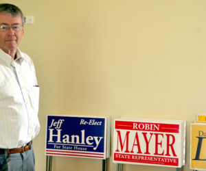 Lincoln County Republican Committee Chairman John O'Connell stands next to stacks of campaign signs in the committee's headquarters in Damariscotta on Wednesday, July 27. (Abigail Adams photo)