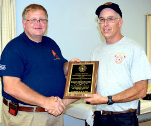 Jefferson Fire Chief and Lincoln County Fire Chiefs Association Vice President Walter Morris (left) presents the association's Officer of the Year Award to Somerville Fire Chief Mike Dostie. (J.W. Oliver photo)