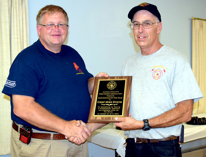 Jefferson Fire Chief and Lincoln County Fire Chiefs Association Vice President Walter Morris (left) presents the association's Officer of the Year Award to Somerville Fire Chief Mike Dostie. (J.W. Oliver photo)