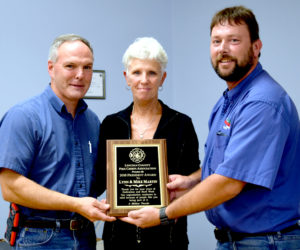 From left: Mike and Lynn Martin accept the Lincoln County Fire Chiefs Association President's Award from Neal Kimball. (J.W. Oliver photo)