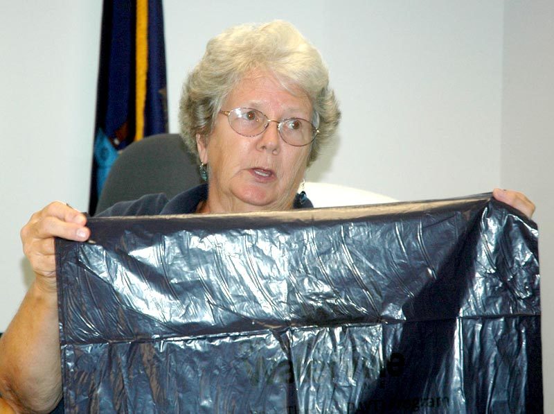 Waldoboro Selectman Katherine Winchenbach holds up one of the pay-as-you-throw bags used in Waterville during a public hearing on whether to send pay-as-you-throw to voters. (Alexander Violo photo)