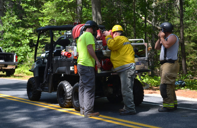 Firefighters prepare to send a Boothbay Fire Department all-terrain vehicle to the location of a brush fire off Willow Lane in Wiscasset the afternoon of Monday, Aug. 8. (Abigail Adams photo)