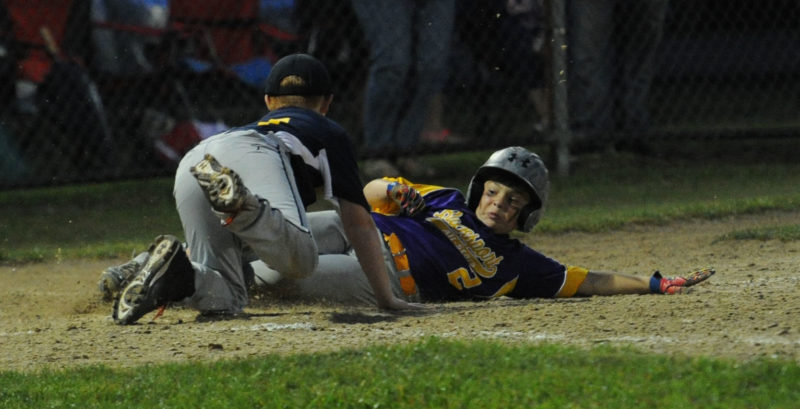 Bucksport's Ayden Maguire scores on a passed ball, as Medomak catcher Kyle Smith makes the catch. (Paula Roberts photo)