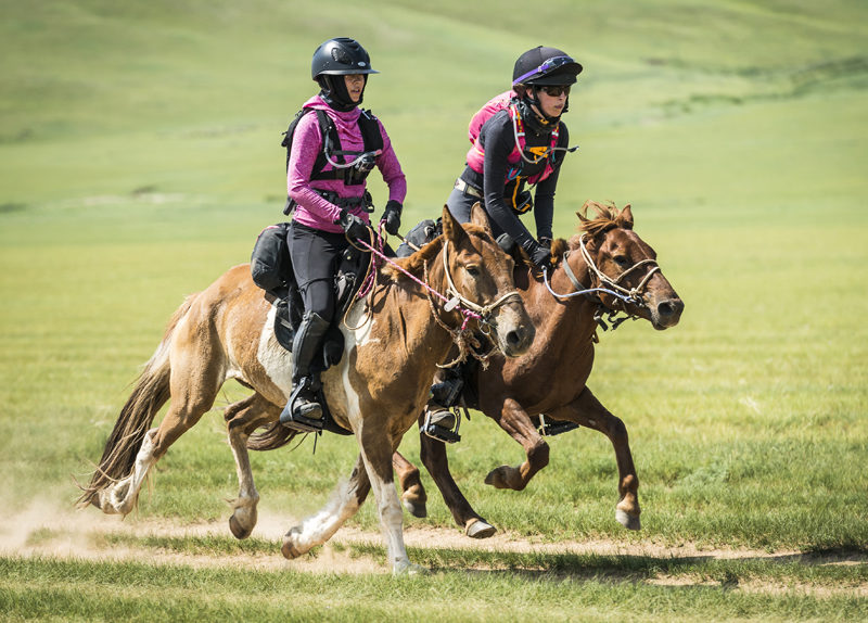 Newcastle native Julia Stewart (right) and another rider compete in the Mongol Derby. (Photo courtesy Richard Dunwoody/richarddunwoodyphotography.com)