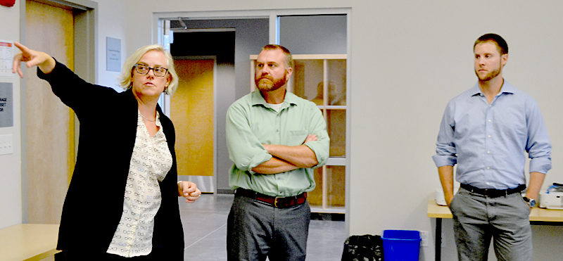 From left: Lincoln Academy Director of Innovation and Technology Maya Crosby points out a feature of a classroom in the Cable-Burns Applied Technology and Engineering Center to Daniel Burne and Alexander Wheelock, both of Becker Structural Engineers and members of the Maine chapter of the American Institute of Architects, Thursday, Sept. 15. (Maia Zewert photo)