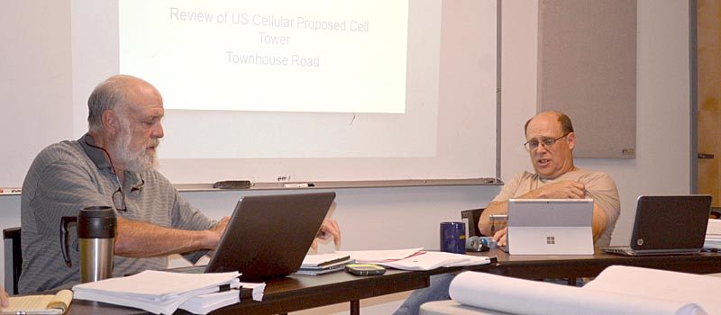 Whitefield Planning Board members Jim Torbert (left) and Glenn Angell review town ordinances to determine if U.S. Cellular's application for a cellphone tower complies during the board's Wednesday, Sept. 14 meeting. (Abigail Adams photo)