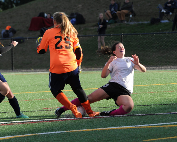 Medomak Valley goalkeeper Chelsea Ripley makes the stop on Lady Eagle Anna Hatch.