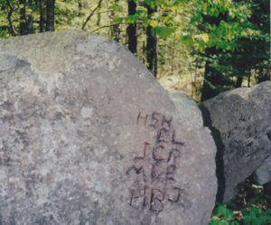 To get an effective photo, we took a black marking pen and carefully traced out the initials on this split rock as best we could. (Arlene Cole photo)