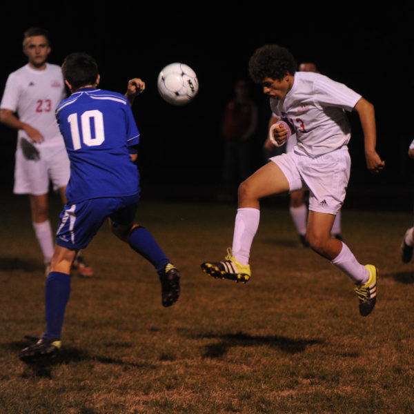 Sam Strozier heads the ball out of the Wolverines defensive end in Wiscasset's 4-1 win over Oak Hill September 29 under the lights in Wiscasset. (Paula Roberts photo)