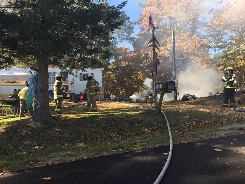 Firefighters work at the scene of a structure fire in Newcastle the afternoon of Wednesday, Oct. 19.