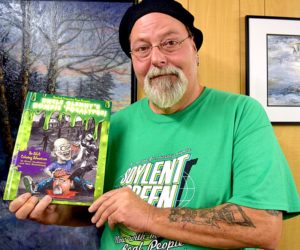 Newcastle artist Glenn Chadbourne holds a copy of his new adult coloring book, "Uncle Glenny's Zombie 'Pocalypse." (J.W. Oliver photo)