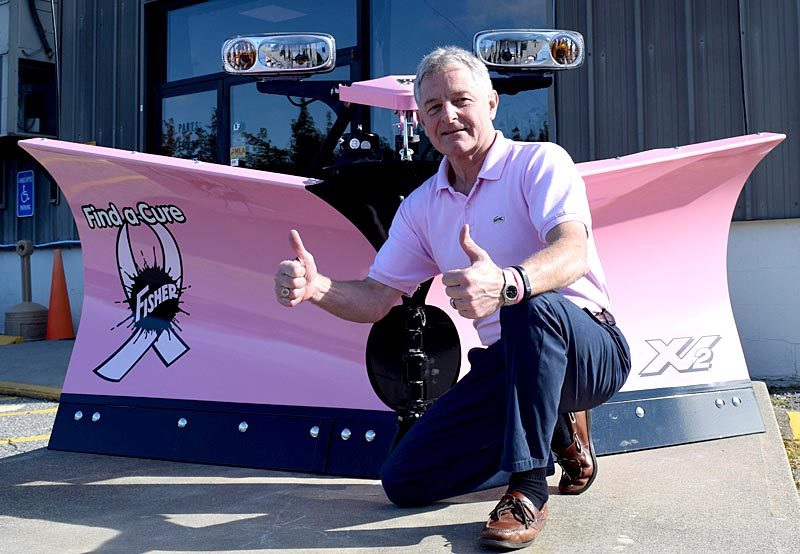 Newcastle Chrysler Dodge Jeep President Randy Miller gives two thumbs up by a Fisher XV2 v-plow at the dealership Monday, Oct. 3. Miller plans to auction the plow at a silent auction to raise money for the American Cancer Society on Wednesday, Oct. 12. (J.W. Oliver photo)