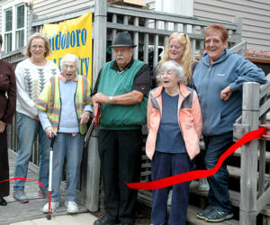 Waldoboro Food Pantry Co-director Lou Cook cuts the ribbon to open the pantry's new location at 251 Jefferson St. From left: Town Manager Linda-Jean Briggs, Tina Cunningham, Jane Lichtman, Cook, Mary Littell (back), Gloria Bowers, Wanda Collamore, and Assessors' Agent Darryl McKenney. (Alexander Violo photo)